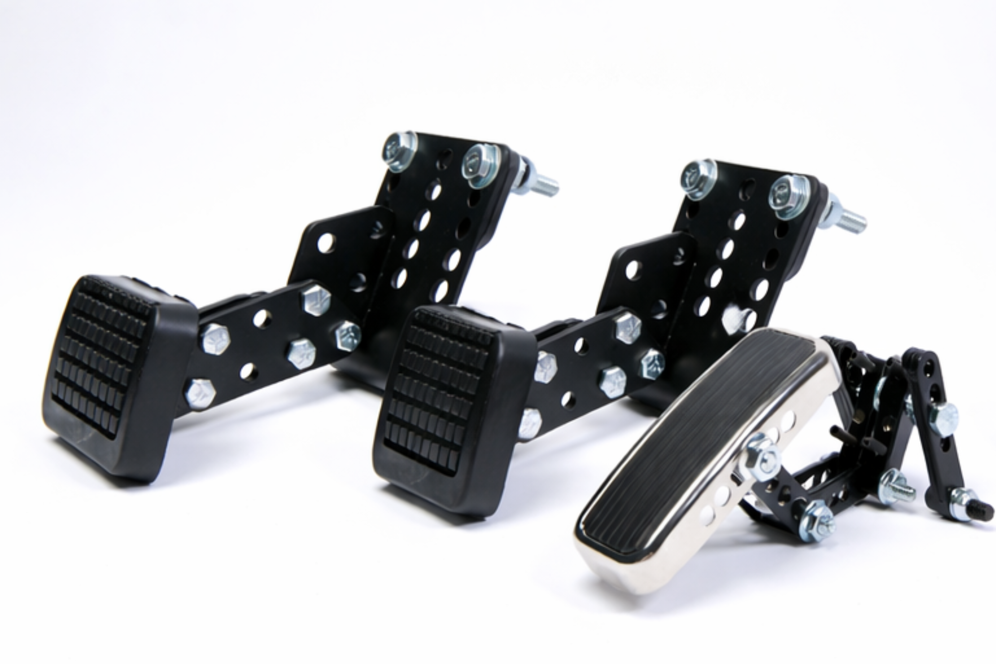 Adjustable PedalMates gas, brake, and clutch pedal extenders with durable metal brackets and non-slip rubber pedals for improved driving accessibility
